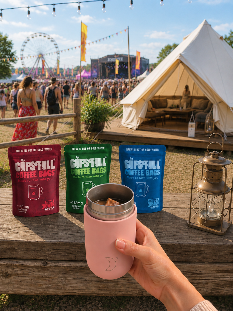 Cups Full coffee bags and a travel cup at a festival campsite