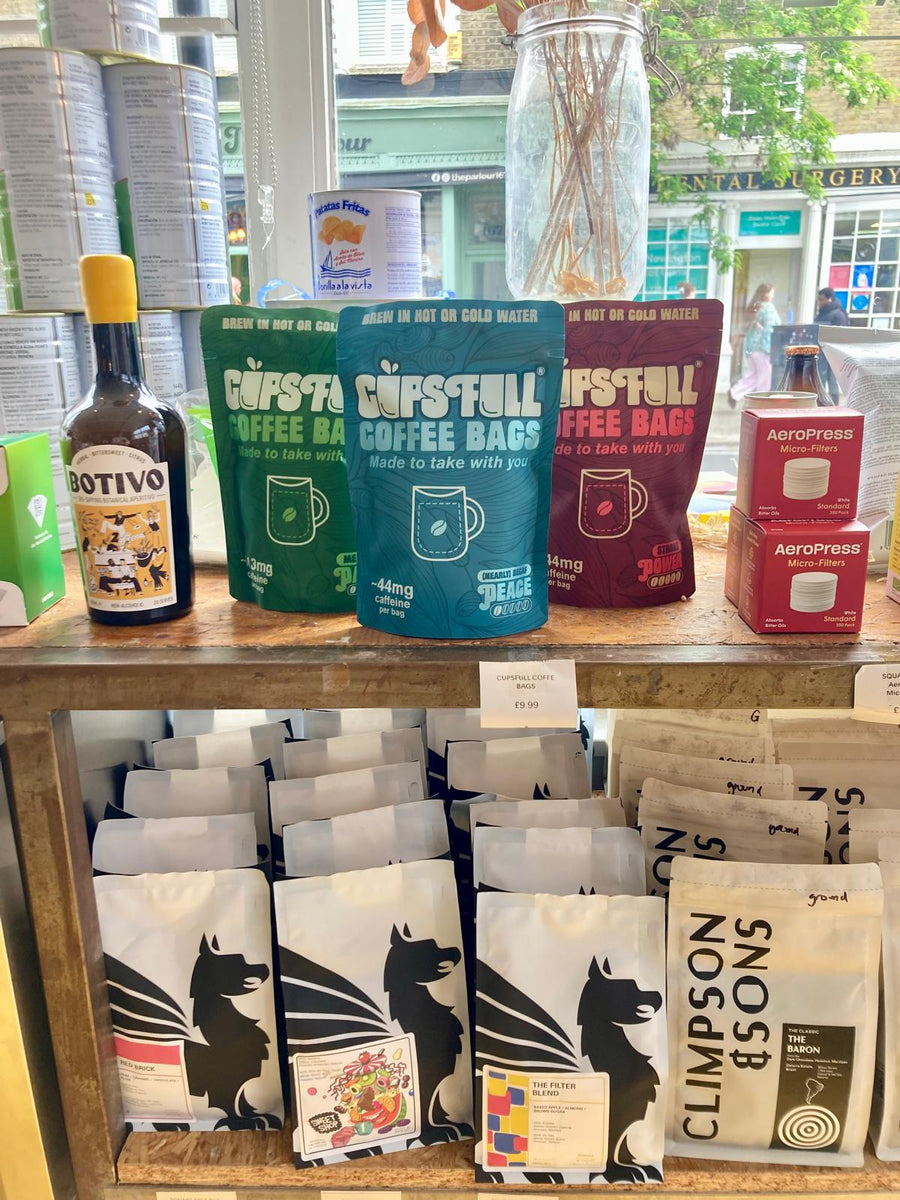 Cups Full coffee bags on display in a deli