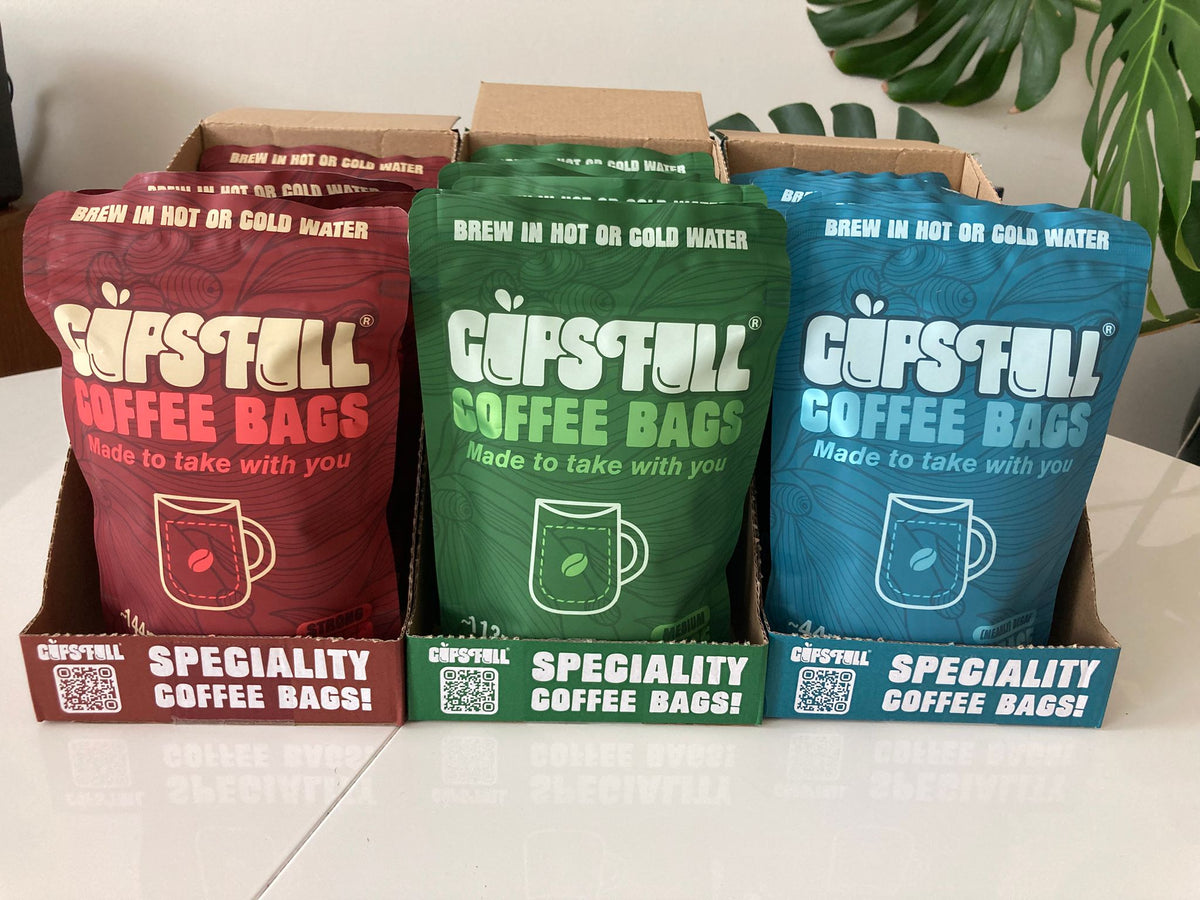 Cups Full Power, Pace and Peace pouches in shelf-ready display boxes
